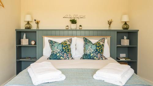 a bedroom with a large bed with pillows at Pipehouse in Bath