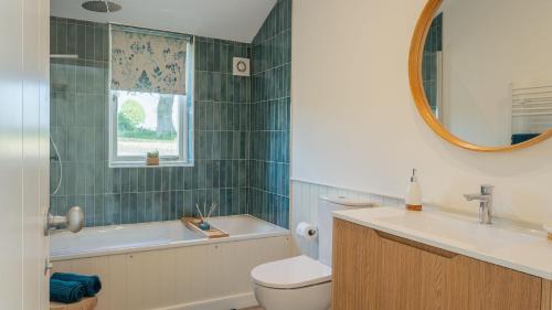 a bathroom with a sink toilet and a mirror at Pipehouse in Bath