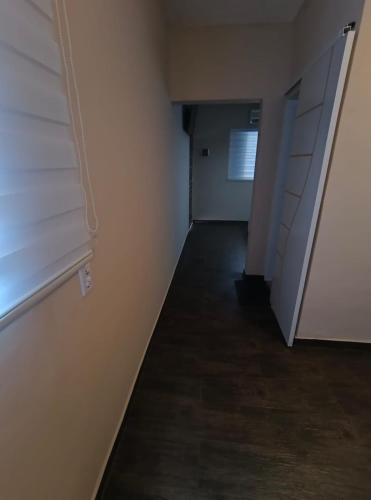 an empty room with a door and a hallway at Pousada chc in Praia Grande