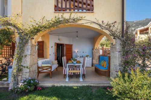 a patio with a table and chairs in a house at Sea view garden in Cala Gonone