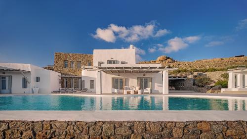 a villa with a swimming pool and a house at Villa Zen Mykonos in Mýkonos City