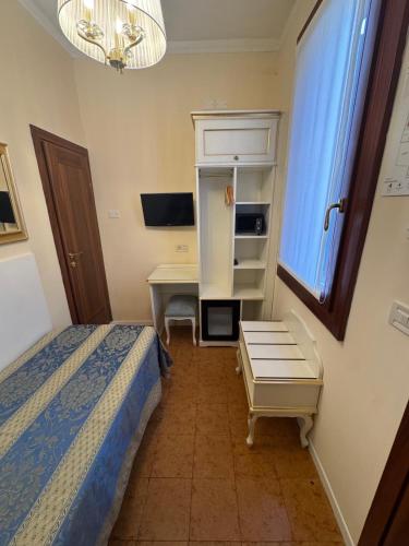 Ένα ή περισσότερα κρεβάτια σε δωμάτιο στο Hotel Tivoli