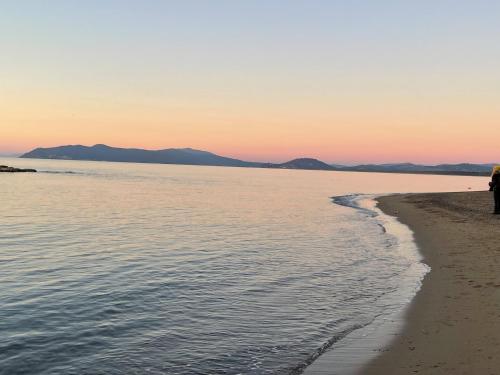 a person walking on the beach at sunset at Smile in Manciano