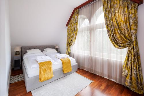 a bedroom with two beds and a large window at Uhu Villa 750 m2 - Budapest in Budapest