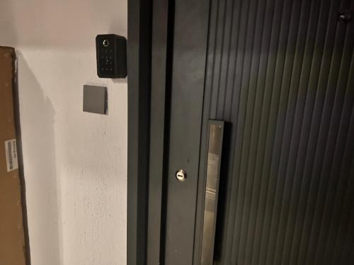 a door with a lock on a wall at Mimah's cozy getaway near JKIA at Taurus Residences in Nairobi
