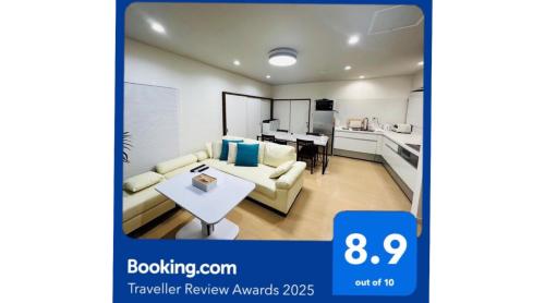 a picture of a living room with a couch and a table at Eternity Marina HOUSE ONJUKU in Onjuku