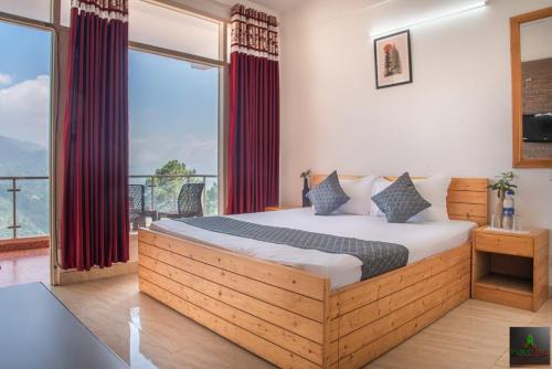 a bedroom with a large bed and a large window at Exotic Stays I The Village Retreat Kasauli in Kasauli