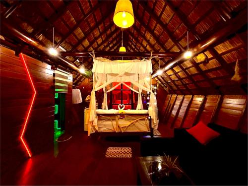 a room with a bed in a yurt with lights at Chika's Place River View Udawalawa in Udawalawe