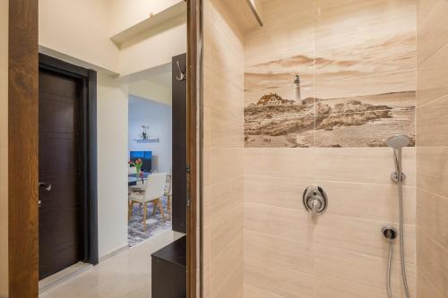 a bathroom with a shower with a painting on the wall at Stylish TOP center Flat 100m to Vitosha blvd in Sofia