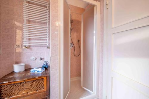 a bathroom with a shower and a sink next to a door at Appartamento Al Filarmonico in Verona