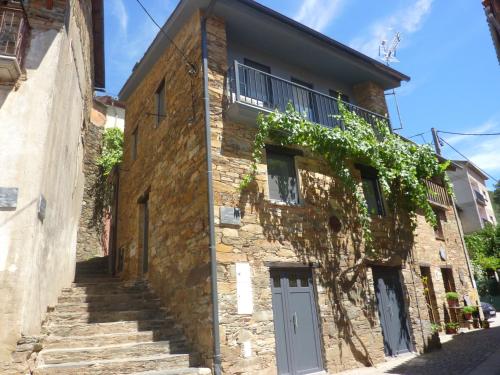 an old stone building with stairs in front of it at Casa da Sobreira in Sobral de São Miguel