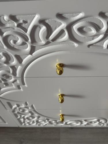 a white ceiling with two gold balls on it at Suite Elisir Egitto Domina Coral Bay Resort in Sharm El Sheikh