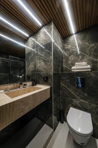 a bathroom with a toilet and a sink at Blue Suite in Netanya
