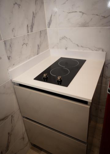 a white counter with a stove in a bathroom at Seaside Escape at Luquillo Beach - Palma Luxe Studio in Luquillo