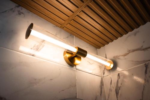 a light on a wall with a bottle on it at Seaside Escape at Luquillo Beach - Palma Luxe Studio in Luquillo