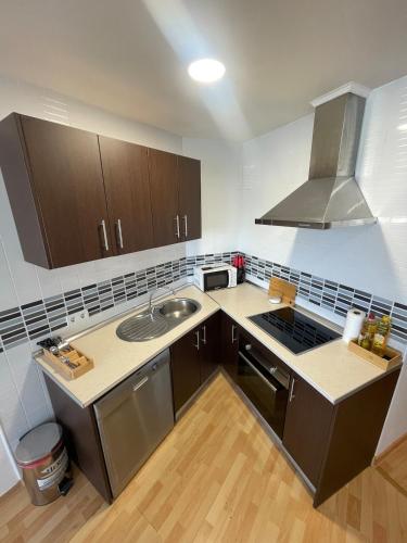 a small kitchen with a sink and a stove at Top Costa del Sol in Torremolinos