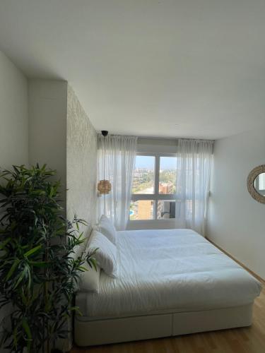 a bedroom with a bed and a window at Top Costa del Sol in Torremolinos