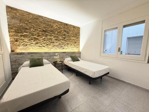 Ένα ή περισσότερα κρεβάτια σε δωμάτιο στο Agi Pi Sunyer Apartments