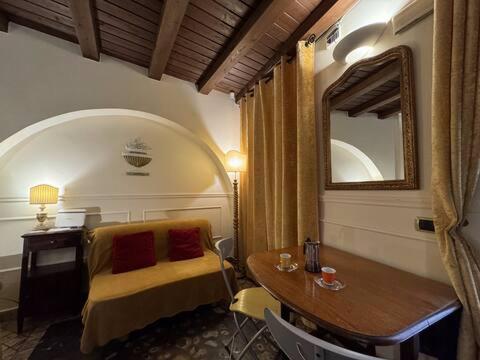 a room with a desk and a table and a mirror at Loft Navona - Centro Storico in Rome