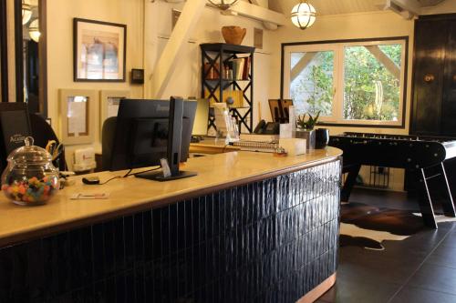 an office with a desk with a computer and a piano at Best Western Hotel Acadie Paris Nord Villepinte in Tremblay En France