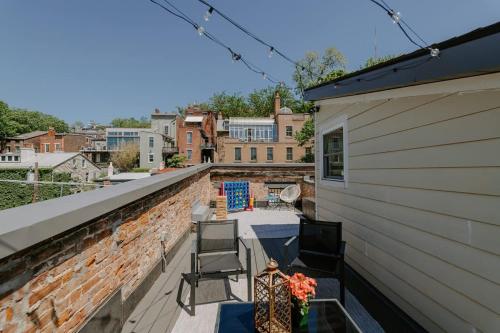 a balcony with two chairs and a building at Stunning 4BR Townhome Rooftop City Views in Cincinnati