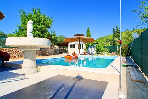 a swimming pool with a fountain next to a house at Holiday Home Marco's Place in Vela Luka