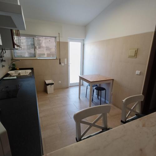 a kitchen with a table and chairs in a room at Lagos Charming Villas in Lagos