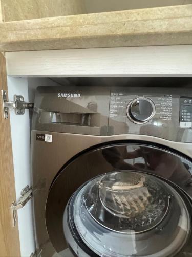 a close up of a washing machine in a kitchen at Suite Elisir Egitto Domina Coral Bay Resort in Sharm El Sheikh