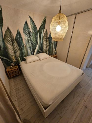 a bed in a room with a wall with plants at La Riviera in Saint-Denis