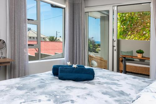 a bedroom with a large bed with a large window at Stylish OceanBreeze 50 Central Mossel Bay in Mossel Bay