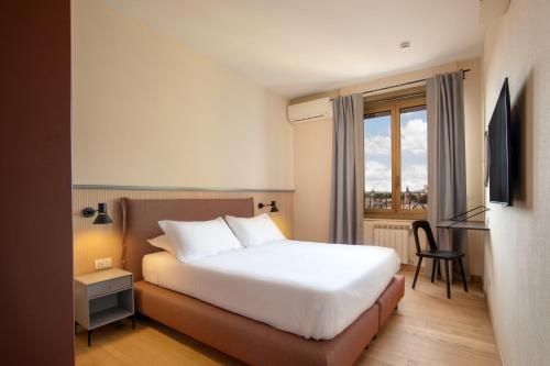 Ένα ή περισσότερα κρεβάτια σε δωμάτιο στο Hotel Colosseum