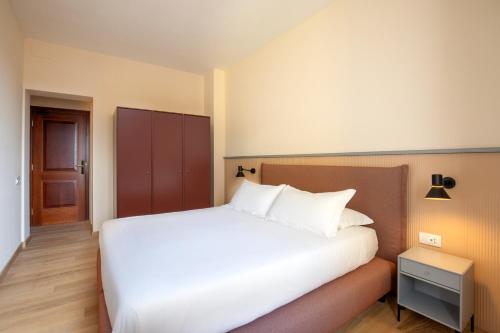 Ένα ή περισσότερα κρεβάτια σε δωμάτιο στο Hotel Colosseum