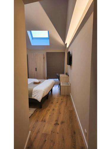 a bedroom with a bed and a skylight at Chez Agnès in Auzéville-en-Argonne