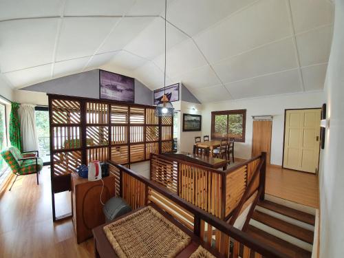 a large room with wooden floors and a staircase at Kayube Estate Bungalows in Livingstone