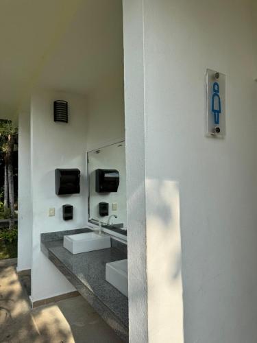 a bathroom with two sinks and a mirror on the wall at Casa Puerto Paraíso in Puerto Morelos