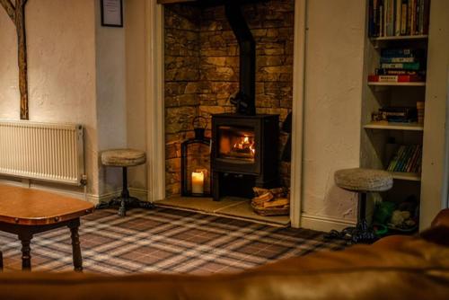 a fireplace in a living room with a stove at Grains Bar Hotel in Oldham