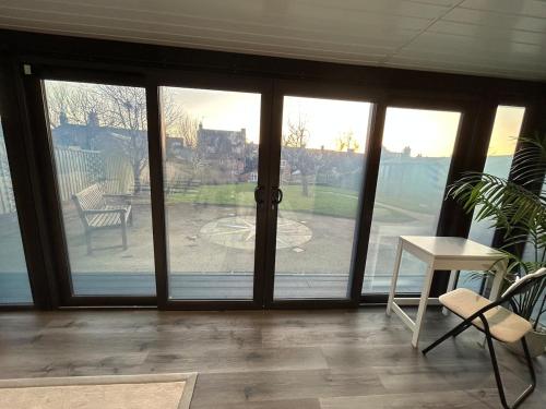 a room with sliding glass doors with a view of a yard at Luxury and Style - The Garden Room in Winslow
