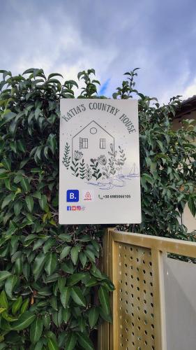 a sign on a fence with a house on it at Katia 's Country House in Sikión