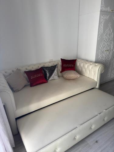a white couch with pillows on it in a room at Suite Elisir Egitto Domina Coral Bay Resort in Sharm El Sheikh