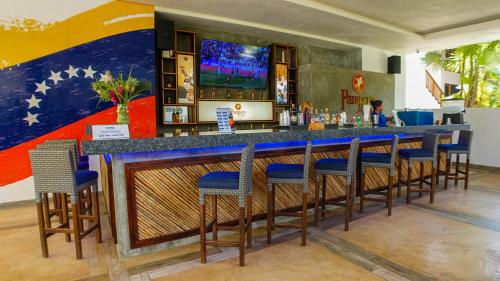a bar in a restaurant with a mural on the wall at Sunsol Ecoland in Pedro Gonzalez