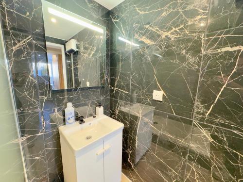 a bathroom with a sink and a mirror at Suite Romantique - Balneo Privé - Parking in Douai