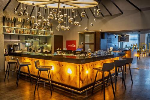 a bar in a restaurant with bar stools at Renaissance by Crystall in Atyraū