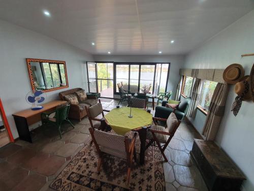 a living room with a table and chairs at Kayube Estate Bungalows in Livingstone