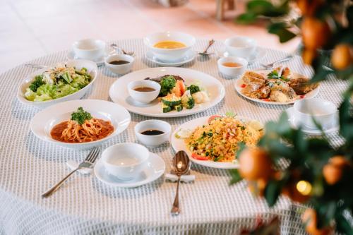 a table with many plates of food on it at Anans Home Ha Giang - Tours & Motorbike Rental in Ha Giang