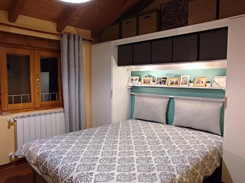 un dormitorio con una cama en una habitación en Oasi Azzurra - Cosy flat with a terrace and a great view over lake and mountains, en Fonteno