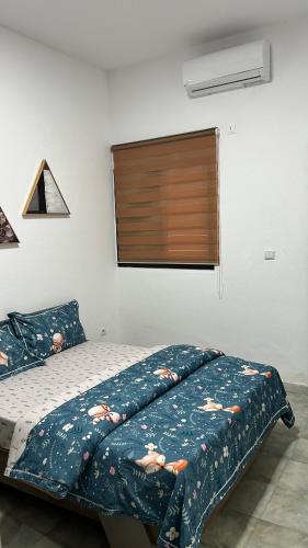 una camera da letto con un letto con una coperta sopra di WID appartement a Abidjan