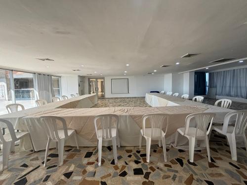 a large conference room with a long table and chairs at Hotel Costa del Sol in Cartagena de Indias