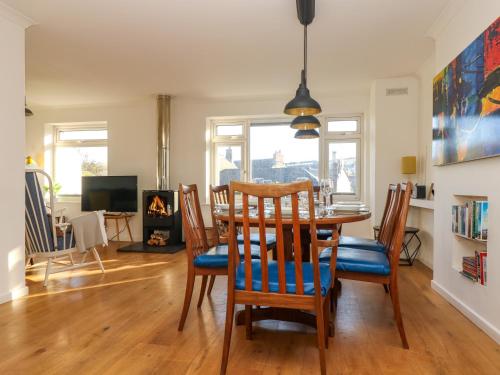 a dining room with a table and chairs at Rock Pool House in Helston