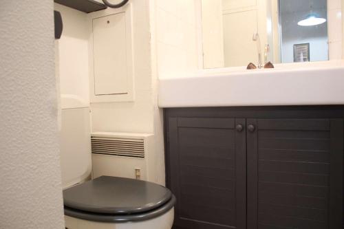 La salle de bains est pourvue de toilettes noires et d'un lavabo. dans l'établissement Appt T1 bis mezza ILE DE RE - IDR400-057, à Saint-Martin-de-Ré