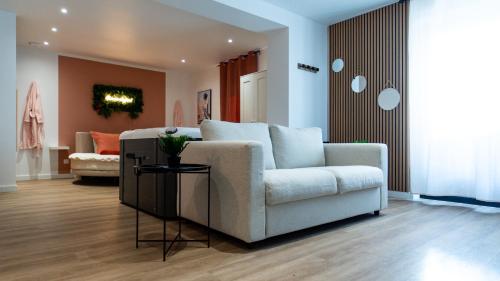 a living room with a couch and a chair at Comme chez soi - Amiens in Amiens